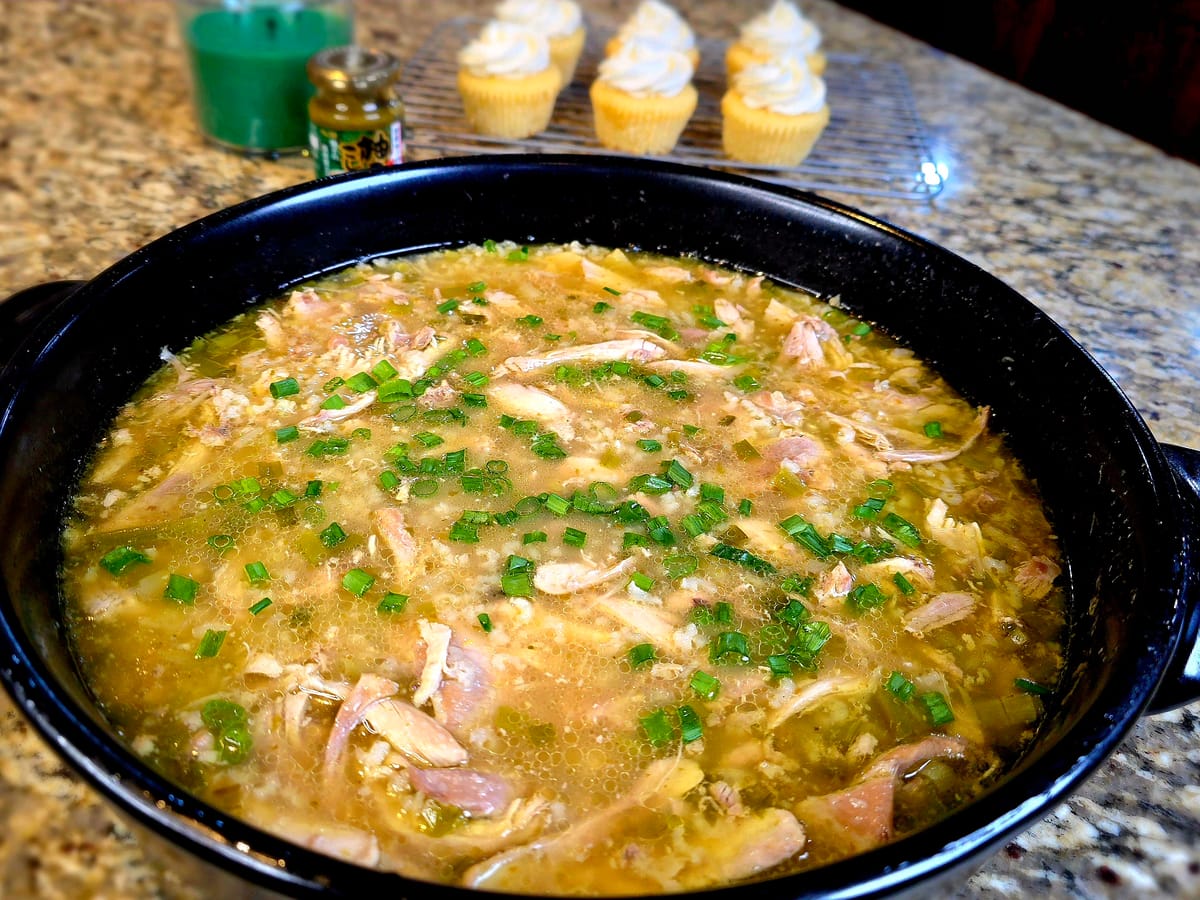 One-pot chicken and rice with corn and Parmesan cheese in a white bowl, garnished with fresh herbs