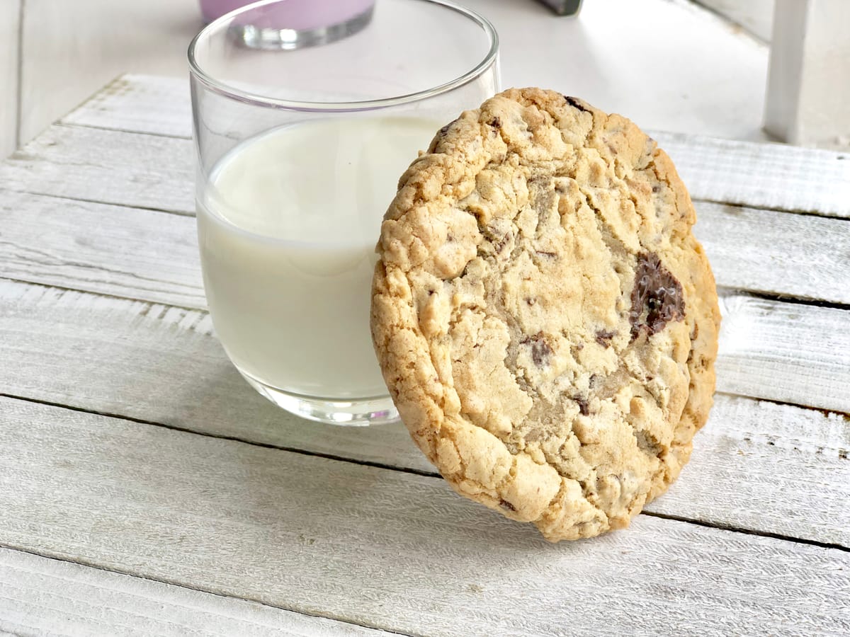 Homemade chocolate chip cookies with semi-sweet chocolate chips on a light background