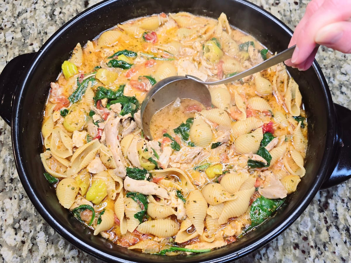Creamy Marry Me Chicken Soup in a white bowl with tender chicken pieces, sun-dried tomatoes, and fresh herbs garnish