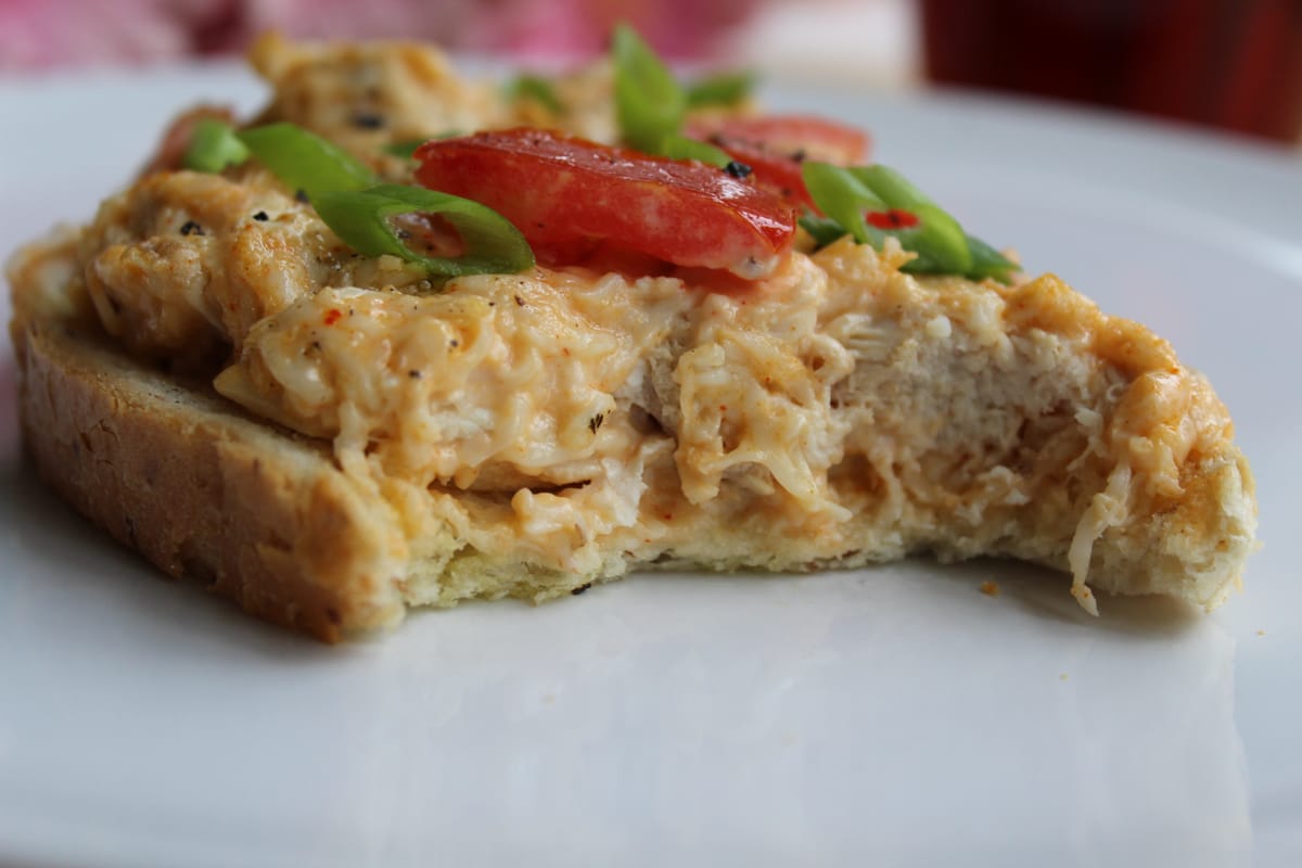 Golden chicken tomato melt sandwich with melted cheese and fresh tomato slices on toasted bread