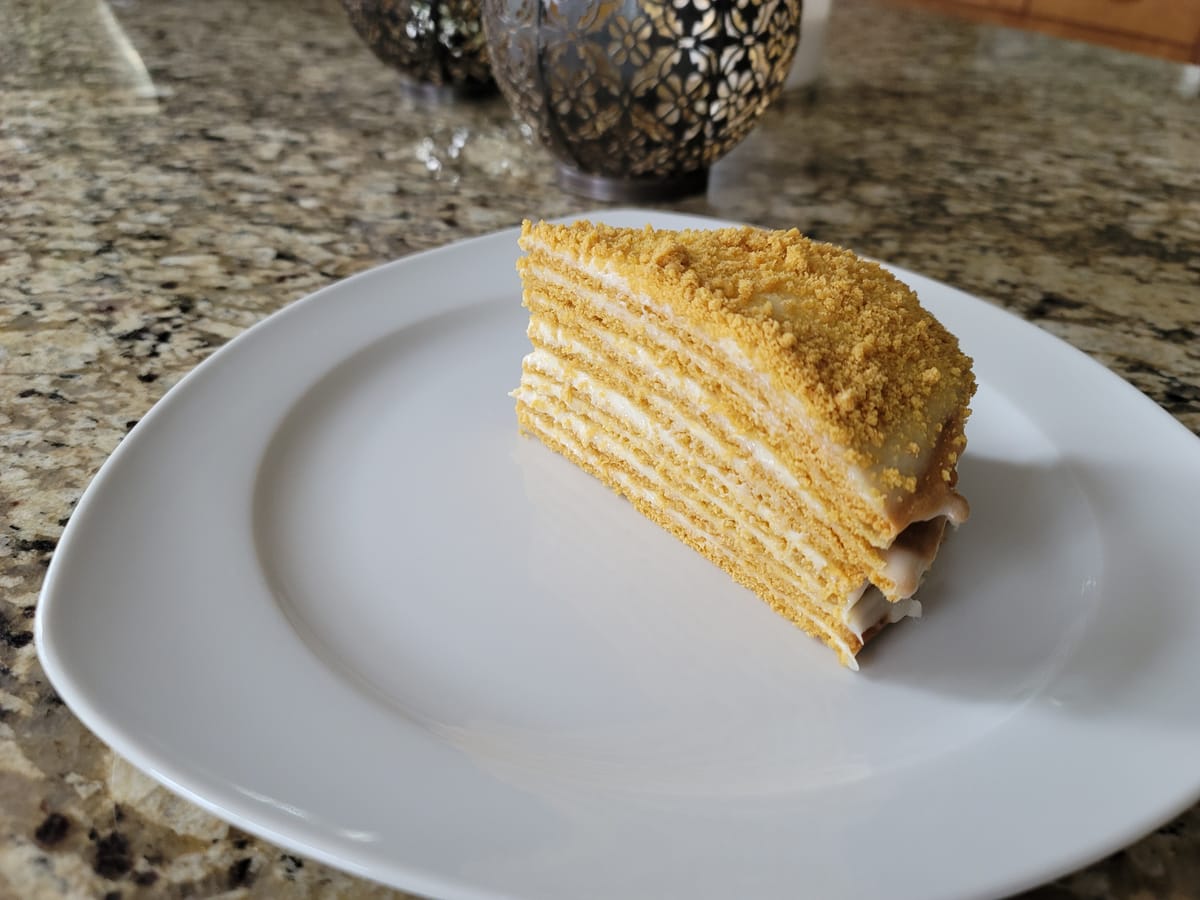 Golden-brown traditional honey cake with rich caramel color, sliced to show moist tender crumb interior